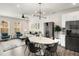 Open concept dining area with kitchen view, hardwood floors and modern light fixture at 1590 Ridgebrook Downs, Mableton, GA 30126