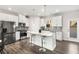 Kitchen features white cabinets, stainless steel appliances, a center island with seating, and herringbone tile backsplash at 1590 Ridgebrook Downs, Mableton, GA 30126