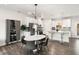 Modern kitchen featuring stainless steel appliances, an island with bar stools, and a dining area at 1590 Ridgebrook Downs, Mableton, GA 30126