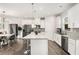 Bright kitchen features stainless steel appliances, granite counters, and a center island with barstool seating at 1590 Ridgebrook Downs, Mableton, GA 30126