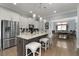 Open concept kitchen with island, stainless steel appliances, and hardwood floors at 2134 Old Georgian Nw Ter, Atlanta, GA 30318