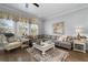 Cozy living room with hardwood floors, fireplace, and large windows at 2134 Old Georgian Nw Ter, Atlanta, GA 30318