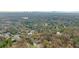 High-angle view shows home's location in a wooded area with city skyline in distance at 5220 Green Oak Ct, Atlanta, GA 30327