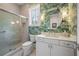 Tropical bathroom with walk-in shower, white vanity, and palm-leaf wallpaper at 5220 Green Oak Ct, Atlanta, GA 30327