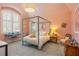 Charming bedroom with a canopy bed and soft pink walls at 5220 Green Oak Ct, Atlanta, GA 30327