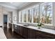 Modern kitchen with sleek cabinetry, marble counters, and large windows at 5220 Green Oak Ct, Atlanta, GA 30327