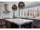 Large kitchen with marble island, stainless steel appliances, and stylish lighting at 5220 Green Oak Ct, Atlanta, GA 30327