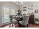 Casual dining area with glass table and gray upholstered chairs at 1508 Denver Way, Locust Grove, GA 30248