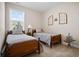 Charming bedroom with two twin beds and neutral decor at 427 Bluffs View Ln, Canton, GA 30114