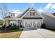 Gray two-story house with a three-car garage and landscaped yard at 427 Bluffs View Ln, Canton, GA 30114