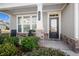 Front porch with stone columns and black front door at 427 Bluffs View Ln, Canton, GA 30114