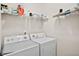 Laundry room with washer, dryer, and ample shelving at 427 Bluffs View Ln, Canton, GA 30114