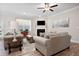 Bright living room with hardwood floors and a cozy fireplace at 427 Bluffs View Ln, Canton, GA 30114