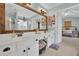 Bathroom with double vanity, view of bedroom, and a large mirror at 615 Keeneland Ter, Woodstock, GA 30189