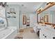 Double vanity bathroom with a large mirror and soaking tub at 615 Keeneland Ter, Woodstock, GA 30189