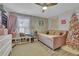 Cozy bedroom featuring a daybed, floral wallpaper, and a pink Christmas tree at 615 Keeneland Ter, Woodstock, GA 30189