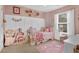 Charming bedroom with a pink color scheme and unicorn decor at 615 Keeneland Ter, Woodstock, GA 30189