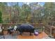 Deck with wooded backdrop, grill and seating at 615 Keeneland Ter, Woodstock, GA 30189