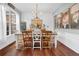 Bright dining room with a farmhouse table, hardwood floors, and neutral wall color at 615 Keeneland Ter, Woodstock, GA 30189