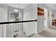 Upstairs hallway with a view to the entryway below at 615 Keeneland Ter, Woodstock, GA 30189