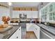 Modern kitchen with granite countertops and white cabinets at 615 Keeneland Ter, Woodstock, GA 30189