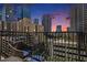 City view from balcony, with wrought iron and chair set during a beautiful sunset at 195 14Th Ne St # 902, Atlanta, GA 30309