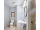 Updated bathroom features pedestal sink, shower, and toilet at 195 14Th Ne St # 902, Atlanta, GA 30309