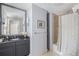 Well-lit bathroom featuring a vanity with granite countertop and a shower/tub combo at 195 14Th Ne St # 902, Atlanta, GA 30309