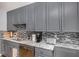 Modern kitchen with granite countertops, stainless steel appliances, and stylish tile backsplash at 195 14Th Ne St # 902, Atlanta, GA 30309