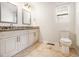 Bathroom featuring double sinks, granite countertops, and tile flooring at 2729 Joyce Ave, Decatur, GA 30032