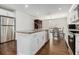 Kitchen with white cabinets, granite countertops, stainless steel appliances, and a center island at 2729 Joyce Ave, Decatur, GA 30032