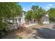 Home exterior with a back patio, white exterior paint, and manicured lawn at 7 W Andrews Nw Dr, Atlanta, GA 30305