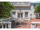 Back patio features brick flooring and an iron table and chairs for outdoor relaxation at 7 W Andrews Nw Dr, Atlanta, GA 30305