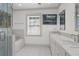 Bright bathroom with double sinks, tub, glass shower, and large window at 7 W Andrews Nw Dr, Atlanta, GA 30305