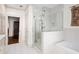 Modern bathroom with glass shower, tub, and elegant white tile at 7 W Andrews Nw Dr, Atlanta, GA 30305