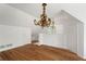 Large bonus room boasts a decorative chandelier, hardwood floors, and versatile space at 7 W Andrews Nw Dr, Atlanta, GA 30305