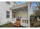 Charming covered porch with brick flooring, white columns, and ceiling fan at 7 W Andrews Nw Dr, Atlanta, GA 30305