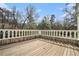 Large wooden deck with a classic white railing, perfect for outdoor entertaining at 7 W Andrews Nw Dr, Atlanta, GA 30305