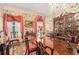 Elegant dining room features a chandelier, a large wooden table, ornate chairs, and floral wallpaper at 7 W Andrews Nw Dr, Atlanta, GA 30305