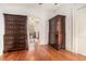 Spacious dressing room featuring hardwood floors and vintage dressers with storage at 7 W Andrews Nw Dr, Atlanta, GA 30305