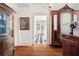 Elegant entryway with hardwood floors, vintage furniture, and view into the checkered-tile hallway at 7 W Andrews Nw Dr, Atlanta, GA 30305