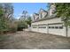 Attached garage with 3 bays, white doors, and black garage coach lights at 7 W Andrews Nw Dr, Atlanta, GA 30305