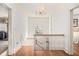 Bright hallway with hardwood floors, chandelier, and access to bedroom and staircase at 7 W Andrews Nw Dr, Atlanta, GA 30305