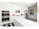 Bright kitchen with white cabinets, stainless steel appliances, and checkered floors at 7 W Andrews Nw Dr, Atlanta, GA 30305