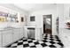 Updated kitchen with black-and-white checkered floors and white cabinetry at 7 W Andrews Nw Dr, Atlanta, GA 30305