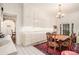 Open concept kitchen with white tile flooring, natural light, and dining table at 7 W Andrews Nw Dr, Atlanta, GA 30305