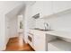Compact kitchenette with modern appliances, white cabinets, and convenient layout at 7 W Andrews Nw Dr, Atlanta, GA 30305