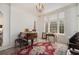 Bright and airy living room with large windows, a piano, and a decorative rug at 7 W Andrews Nw Dr, Atlanta, GA 30305