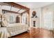 Luxury main bedroom with hardwood floors, canopy bed, fireplace, and abundant natural light at 7 W Andrews Nw Dr, Atlanta, GA 30305