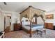 Spacious main bedroom features canopy bed, hardwood floors, and classic decor at 7 W Andrews Nw Dr, Atlanta, GA 30305
